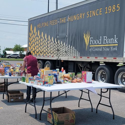 food bank semi truck and folding tables covered with various types of food