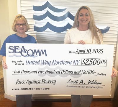United Way CEO accepts big check from SeaComm Branch Manager Jess Roach