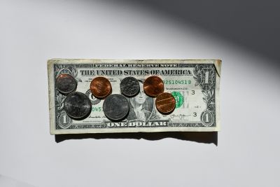 dollar bill with coins on top