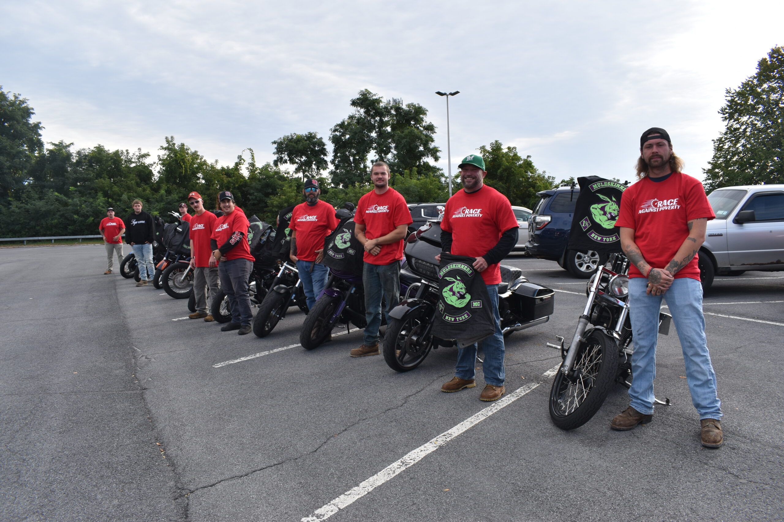 The Muleskinners MC pose with their bikes while volunteering at the Race Against Poverty