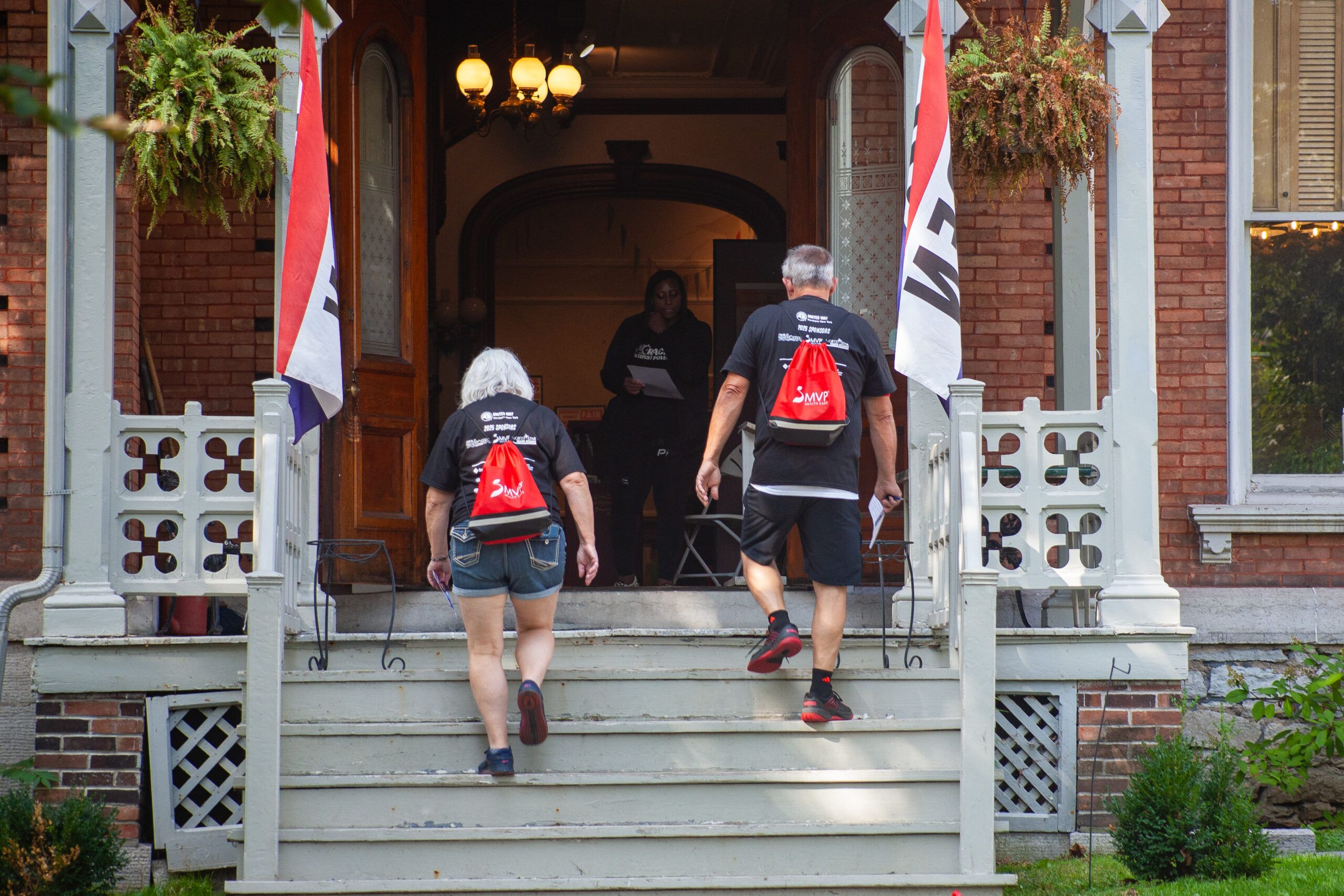 Representatives from SeaComm, a presenting sponsor, pose with their banner