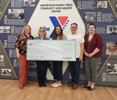 United Way staff present big check to YMCA Executive Director Shawna Cutuli