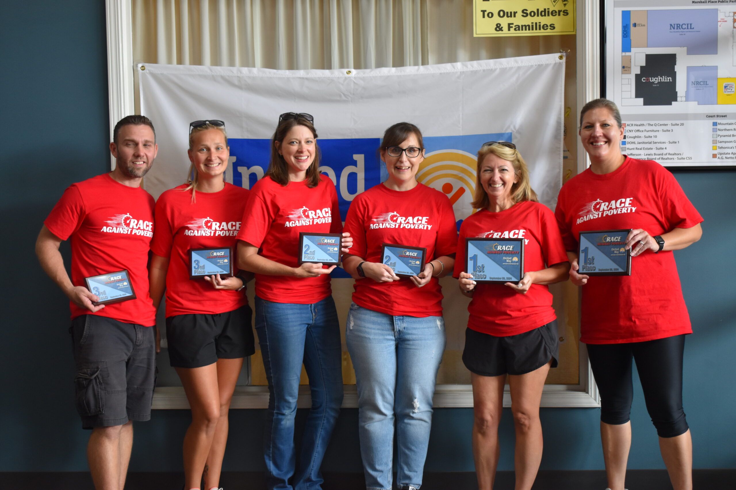 The winners of the 2024 Race Against Poverty smile with their awards