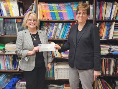 United Way CEO presents check to Cecilia Brock of Literacy of NNY