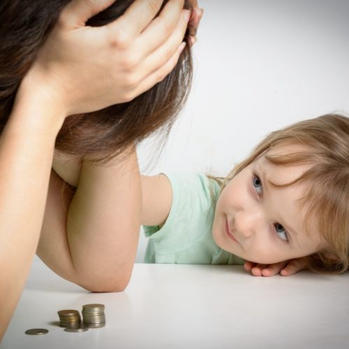 small girl looking up a lady with her head in her hands