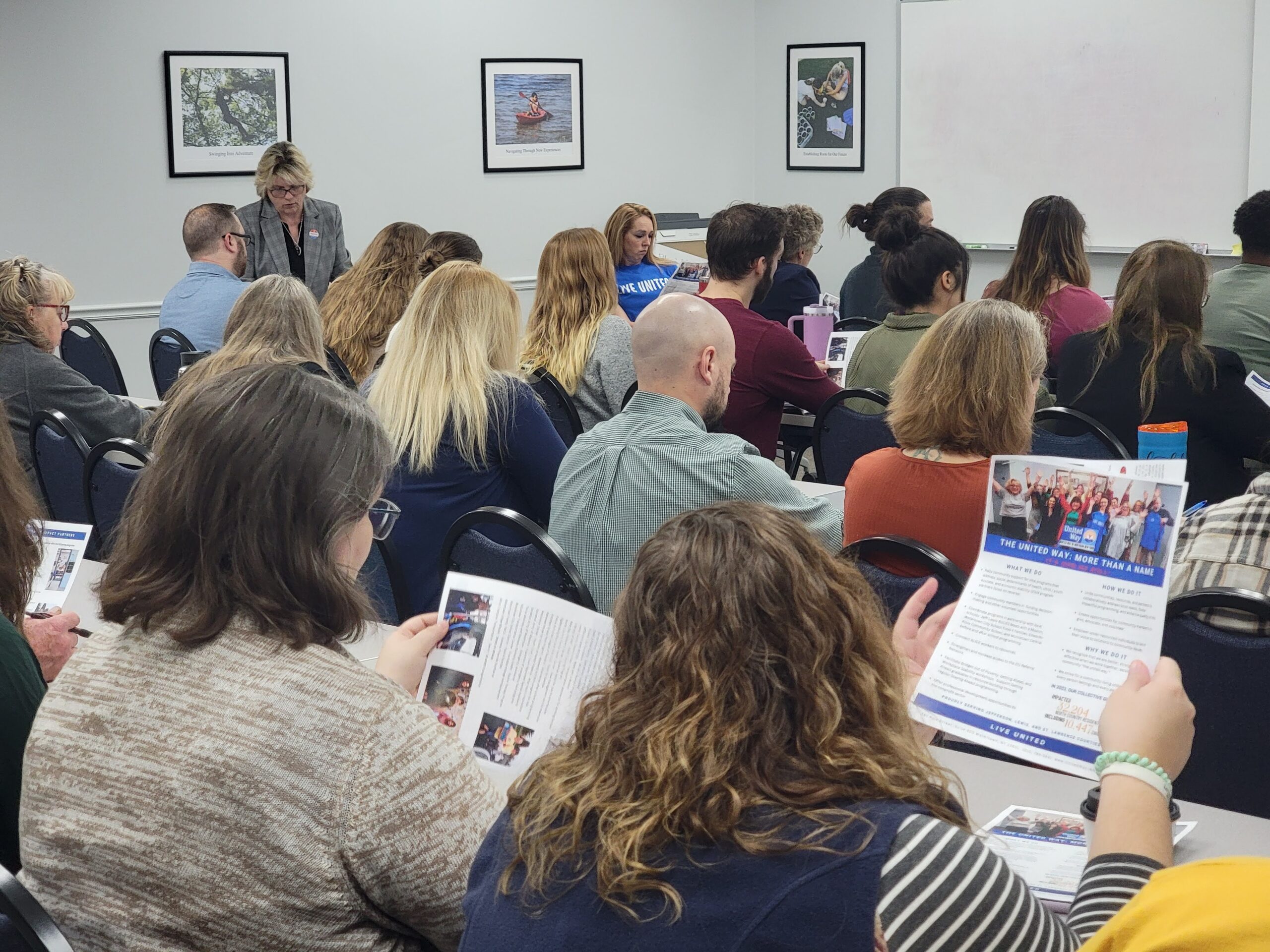 Group of people reviewing United Way handouts during workplace campaign