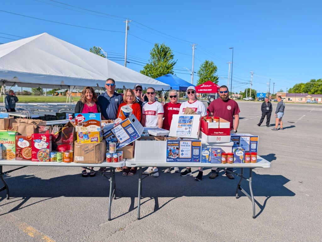 A group of volunteers from Jefferson County stand behind the food they collected.
