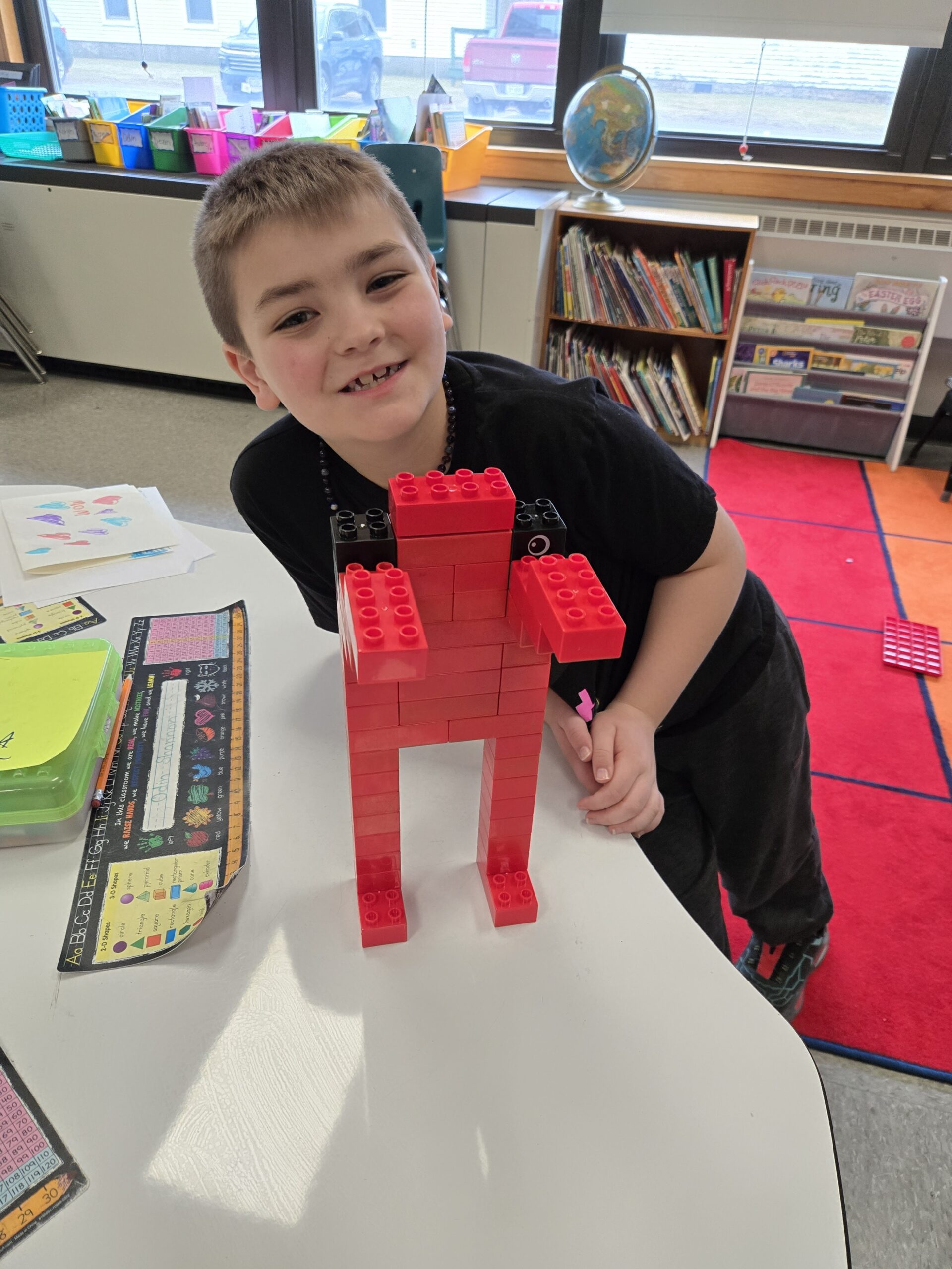 Boy showing off his Lego statue