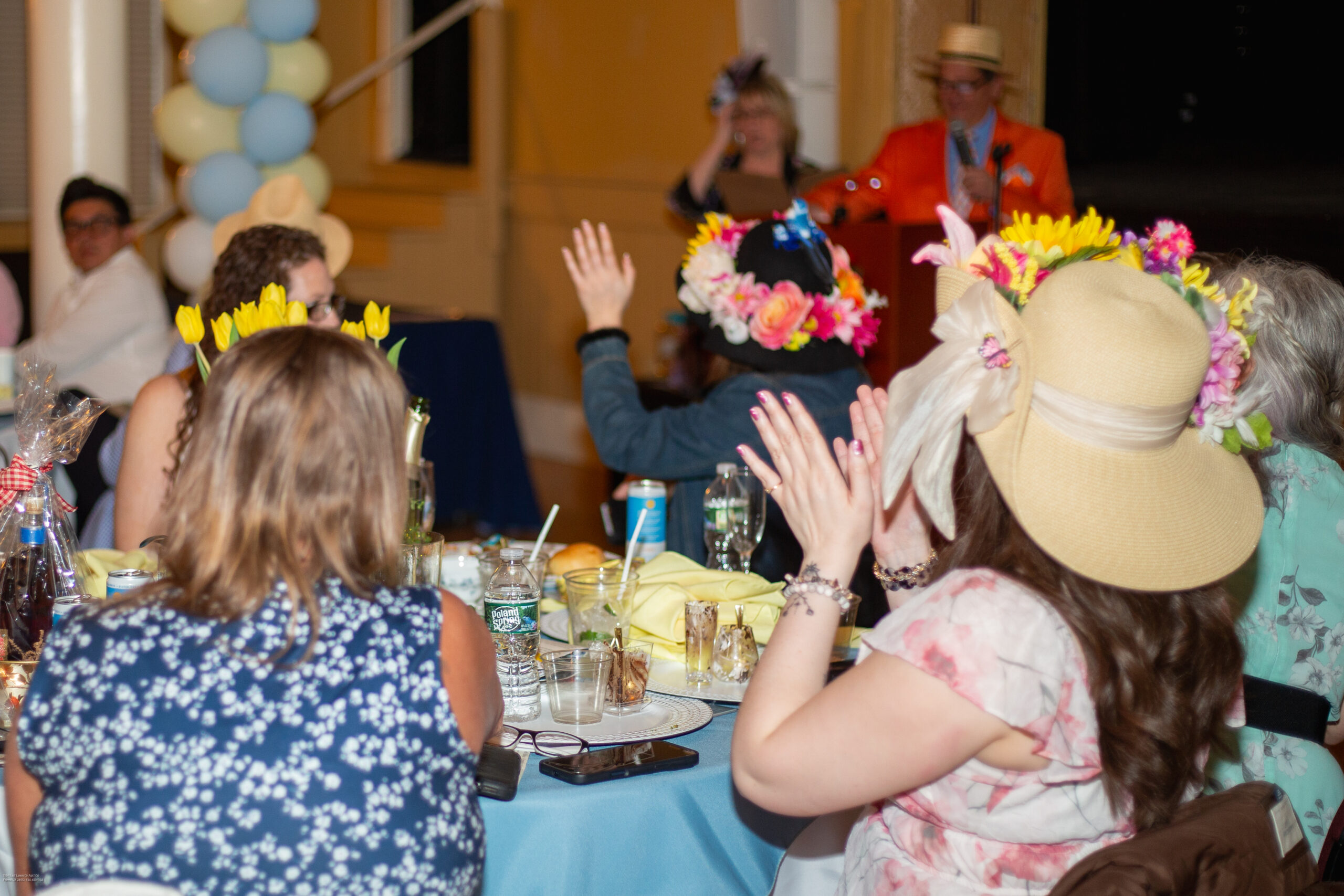 Ladies clapping while seated at table