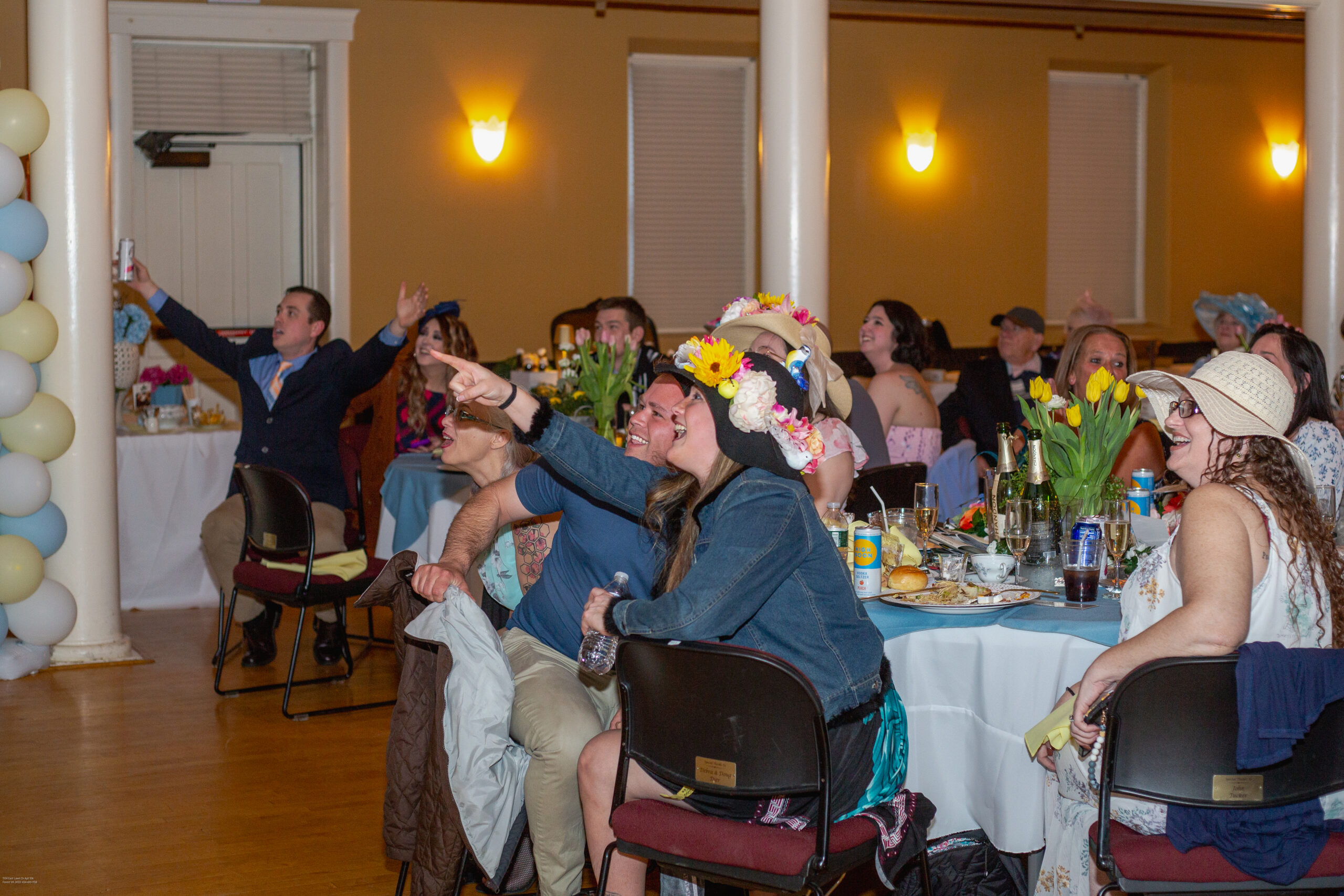 People excitedly pointing at screen while watching the Derby