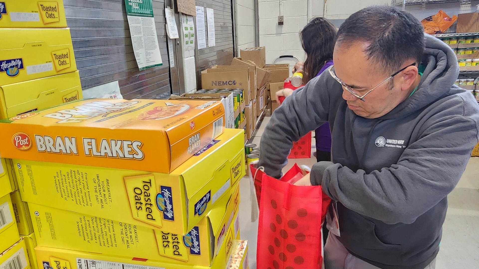 Volunteer packs bag with cereal