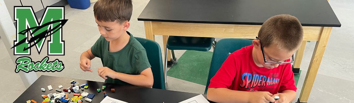 Two boys putting together Lego blocks