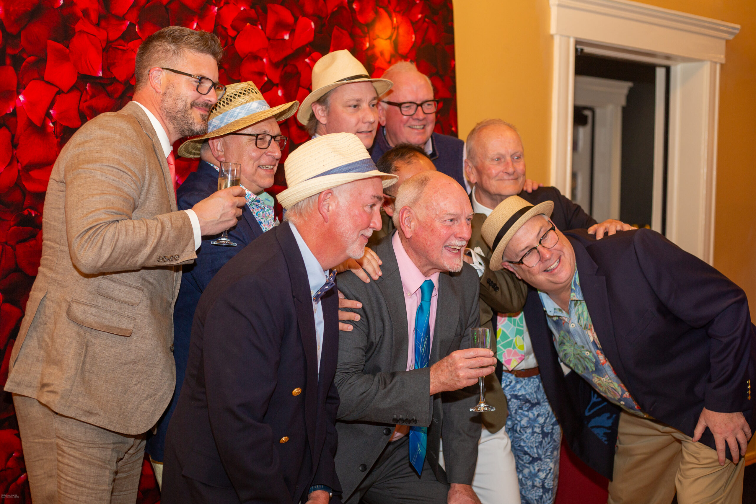 Group of well-dressed men pose for a photo