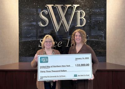 United Way CEO accepts check from Watertown Savings Bank official Amy Moore