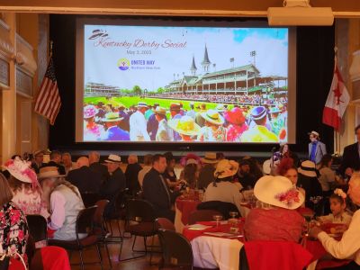 people dressed up clapping with balloons all around at a party
