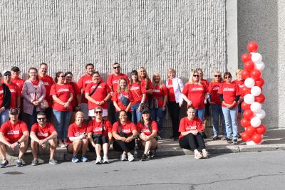 Group of people wearing red Race Against Poverty t-shirts