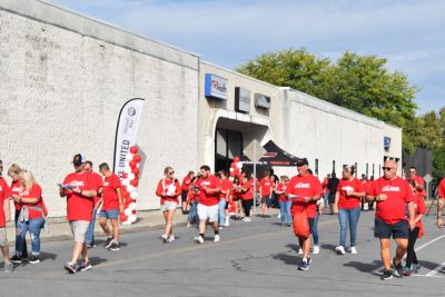 People in red Race Against Poverty t-shirts looking for clues