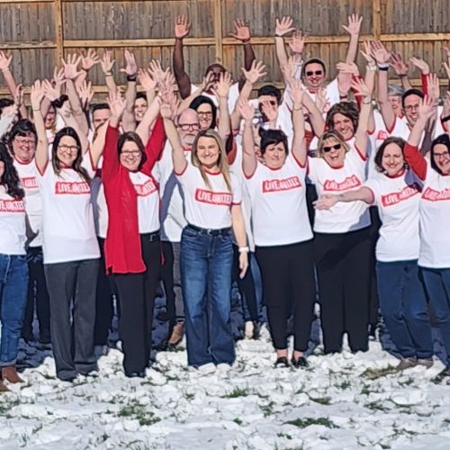 man and woman in business clothes giving eachother a high five