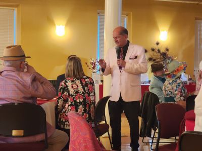a man dressed up in a suit giving a speach at a formal event